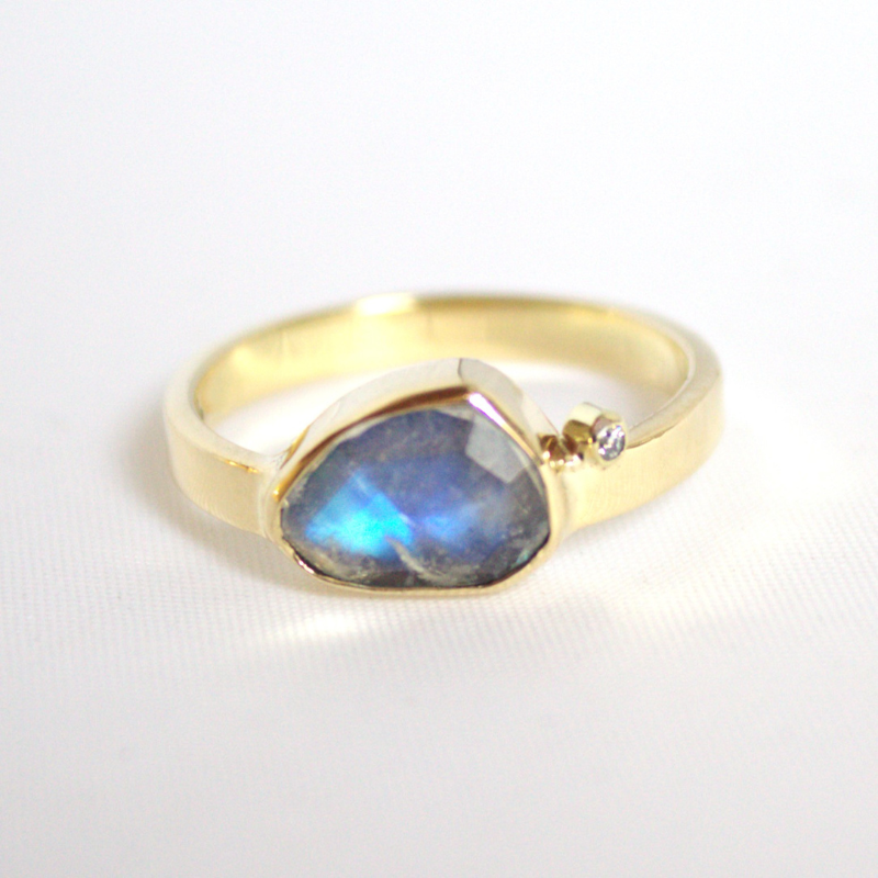 Unieke 14 karaat geelgouden ring met een fantasie geslepen regenboog maansteen en een fijne witte diamant handgemaakt door Goudsmederij Goedbloed